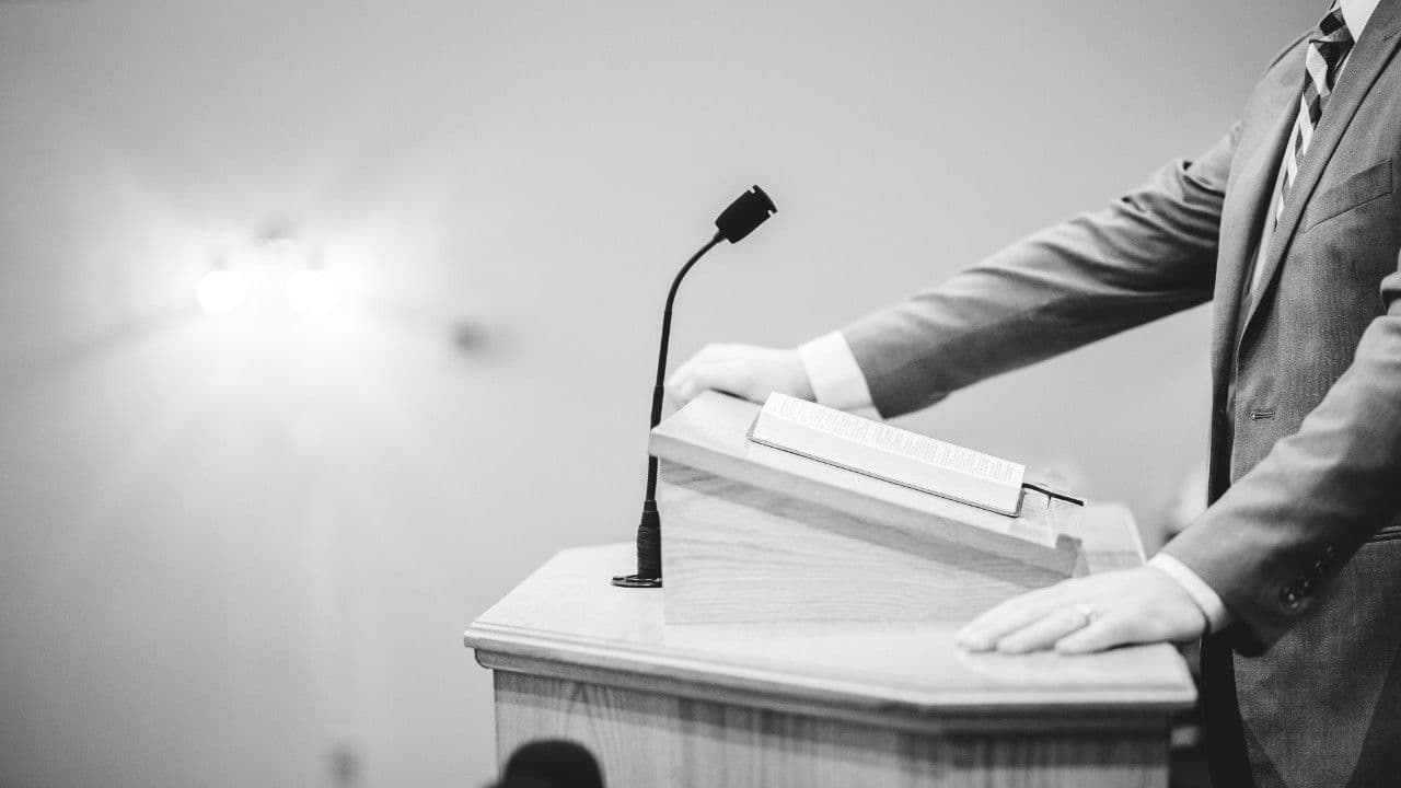 photologuephotos2025-03grayscale-shot-male-speaking-podium_1_0jpg