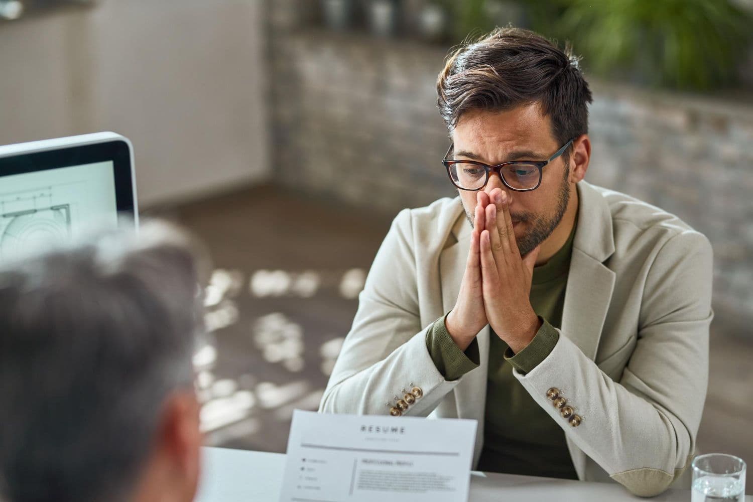 photologuephotos2022-10distraught-young-man-feeling-uncertain-while-having-job-interview-in-the-office_1jpg